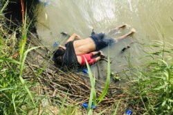 The bodies of Salvadoran migrant Oscar Alberto Martínez Ramírez and his nearly 2-year-old daughter Valeria lie on the bank of the Rio Grande in Matamoros, Mexico, June 24, 2019, after they drowned trying to cross the river to Brownsville, Texas.