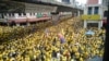 Protesters occupy a street during a rally in downtown Kuala Lumpur, Malaysia, Saturday, Nov. 19, 2016. Tens of thousands of yellow-shirt protesters rallied Saturday in Kuala Lumpur seeking Malaysian Prime Minister Najib Razak's resignation over a financial scandal, undeterred by a police ban and the arrest of more than a dozen activists.