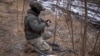 FILE - A Ukrainian serviceman of 47th brigade prepares a Starlink satellite internet system at a front line near the town of Avdiivka in Donetsk region, Ukraine, Feb. 20, 2024.