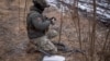 FILE - A Ukrainian service member prepares a Starlink satellite internet system at his positions at a front line near the town of Avdiivka in Ukraine's Donetsk region, Feb. 20, 2024. 