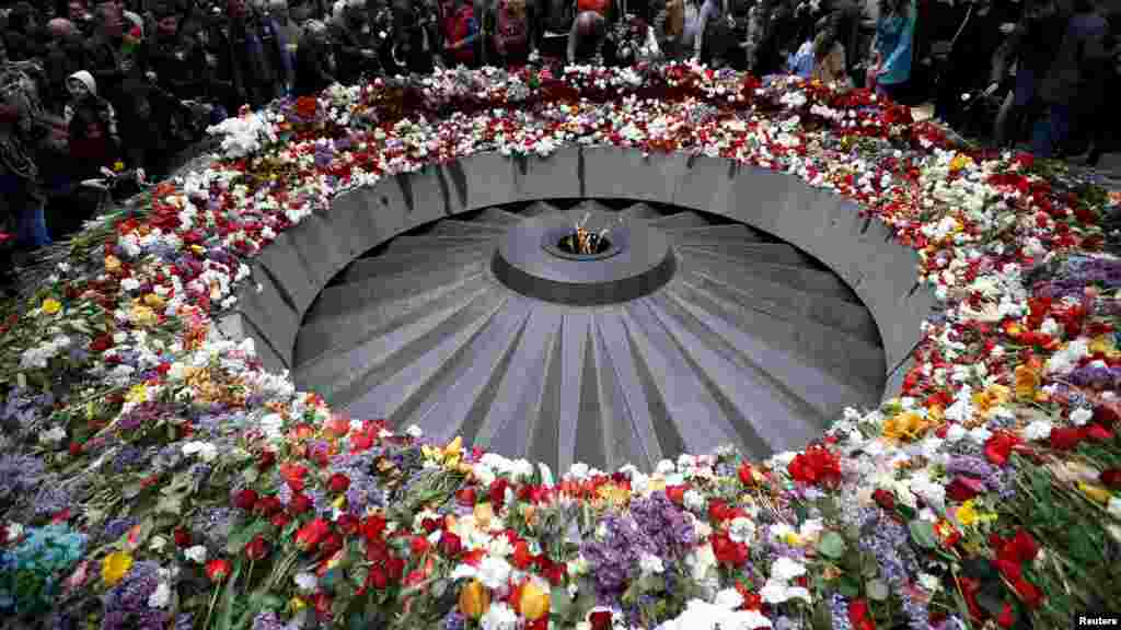 People attend a commemoration ceremony to mark the centenary of the mass killing of Armenians by Ottoman Turks at the Tsitsernakaberd Memorial Complex in Yerevan, Armenia.