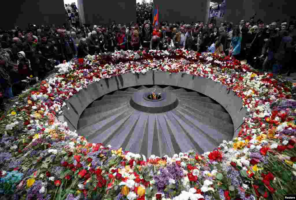 People attend a commemoration ceremony to mark the centenary of the mass killing of Armenians by Ottoman Turks at the Tsitsernakaberd Memorial Complex in Yerevan, Armenia.