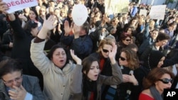 Women gesture during a protest in Tunis, January 29, 2011