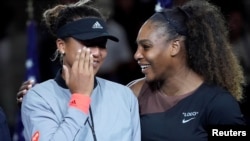 FILE - Naomi Osaka of Japan (left) cries as Serena Williams of the USA comforts her after the crowd booed during the trophy ceremony following the women’s final on day thirteen of the 2018 U.S. Open tennis tournament. (Bob Deutsch/USAToday Sports/Reuters)