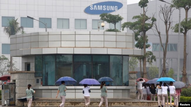 FILE - Employees make their way to work at the Samsung factory in Thai Nguyen province, north of Hanoi, Vietnam, Oct. 13, 2016.