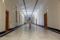 An Afghan Journalist walks inside the Darul Aman Palace which is being used as a temporary health facility for COVID-19 patients in Kabul, Afghanistan, April 18, 2020.