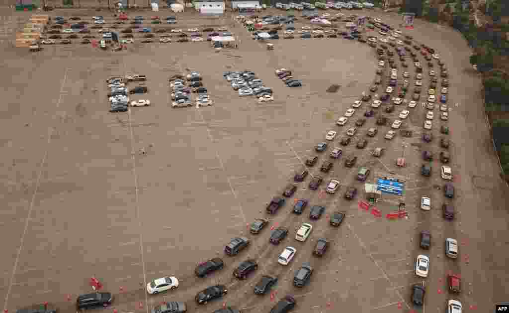 This image from above shows people waiting in line in their cars at a COVID-19 testing center at Dodger Stadium in Los Angeles, California, November 18, 2020.