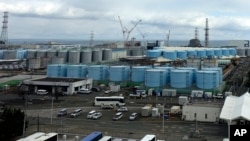 FILE - This photo shows some of about 1,000 huge tanks holding treated but still radioactive wastewater at the Fukushima Daiichi nuclear power plant in Okuma town, northeastern Japan, on Feb. 22, 2023.