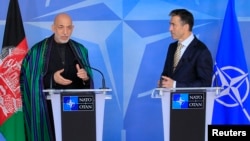 Afghanistan's President Hamid Karzai (L) and NATO Secretary General Anders Fogh Rasmussen make a joint statement before a meeting at NATO headquarters in Brussels, April 23, 2013.