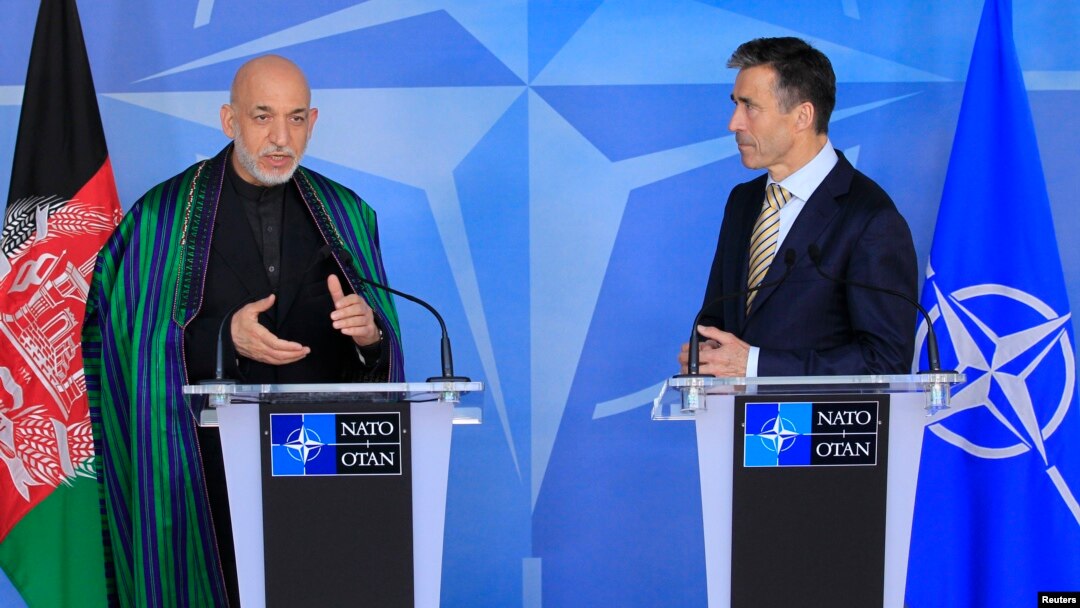 Afghanistan's President Hamid Karzai (L) and NATO Secretary General Anders Fogh Rasmussen make a joint statement before a meeting at NATO headquarters in Brussels, April 23, 2013.