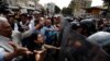 Venezuelan police block a crowd of people gathered to march against the government of President Nicolas Maduro, in Caracas, Venezuela, March 9, 2019.