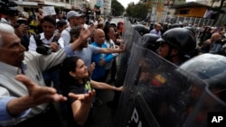 Venezuelan police block a crowd of people gathered to march against the government of President Nicolas Maduro, in Caracas, Venezuela, March 9, 2019.