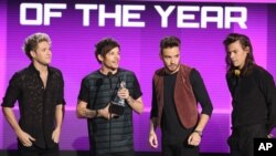 De izquierda a derecha, Niall Horan, Louis Tomlinson, Liam Payne y Harry Styles de One Direction aceptando el premio de Artista del Año de Amercian Music Awards en Los Ángeles, el domingo, 22 de noviembre de 2015.