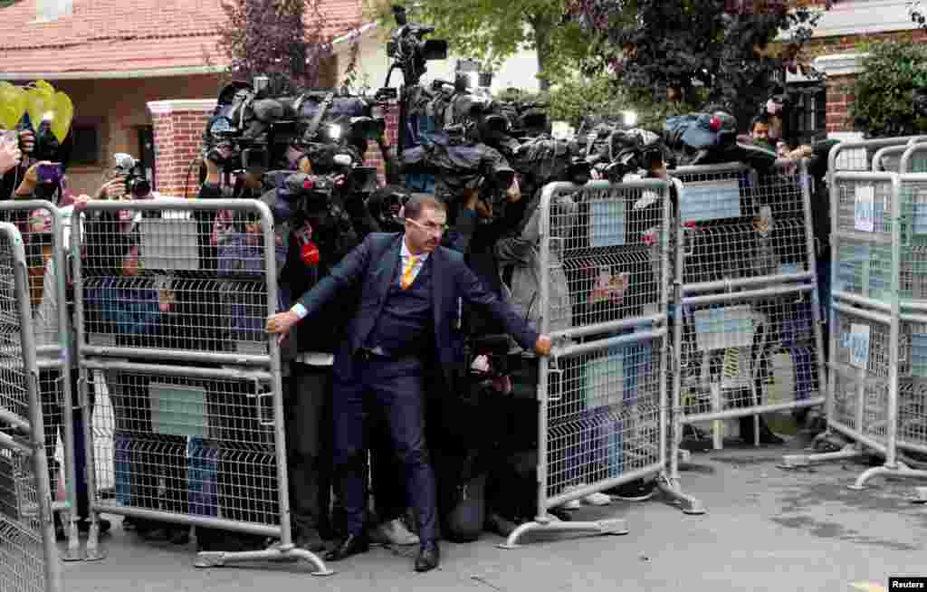 A security official holds barriers during the arrival of Saudi officials at Saudi Arabia&#39;s consulate in Istanbul, Turkey.