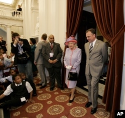 FILE - Queen Elizabeth II and Virginia Gov. Tim Kaine enter the Old House Chamber at the Virginia State Capitol building in Richmond, Va., Thursday, May 3, 2007.