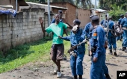 FILE - Burundian police arrest a demonstrator during clashes with security forces in the Cibitoke district of the capital Bujumbura, Burundi, May 29, 2015.