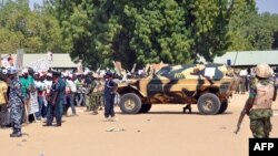 Soldiers and security block a road as they secure the venue during a rally of the ruling People's Democratic Party (PDP) in Maiduguri, Nigeria, Jan. 24, 2015. 