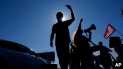 FILE - Students block a highway as they protest President Javier Milei's veto of a law to increase funding for public universities in Buenos Aires, Argentina, Oct. 16, 2024. 