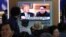 People watch a TV screen showing file footage of U.S. President Donald Trump, left, and North Korean leader Kim Jong Un during a news program at the Seoul Railway Station in Seoul, South Korea, May 16, 2018.