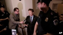FILE - Sen. Rand Paul, R-Ky. holds an impromptu news conference outside a room on Capitol Hill in Washington where he charged House Republicans were keeping their Obamacare repeal-and-replace legislation under lock and key and not available for public view, March 2, 2017.