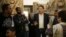 FILE - Stefan Weber, director of the Museum for Islamic Art (C), talks to refugees during a special tour of the complex, in Berlin, Germany, Dec. 16, 2015.