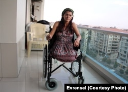 Lisa Calan on her wheelchair while being interviewed by Turkish reporters at her home five months after the Diyarbakir bombing that cost her two legs, Diyarbakir, Turkey, Oct. 2015.