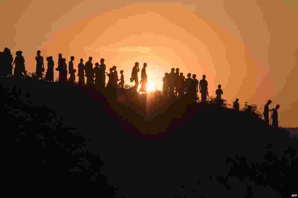 Rohingya Muslim refugees walk down a hillside in the Kutupalong refugee camp in Cox&#39;s Bazar, Bangladesh.