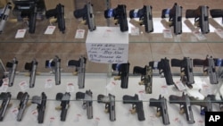 Handguns are on display at B & J Guns in Colonie, New York, June 26, 2008. The Supreme Court ruled that Americans have a constitutional right to keep guns in their homes for self-defense.