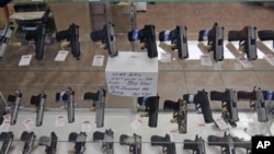 Handguns are on display at B & J Guns in Colonie, New York, June 26, 2008.