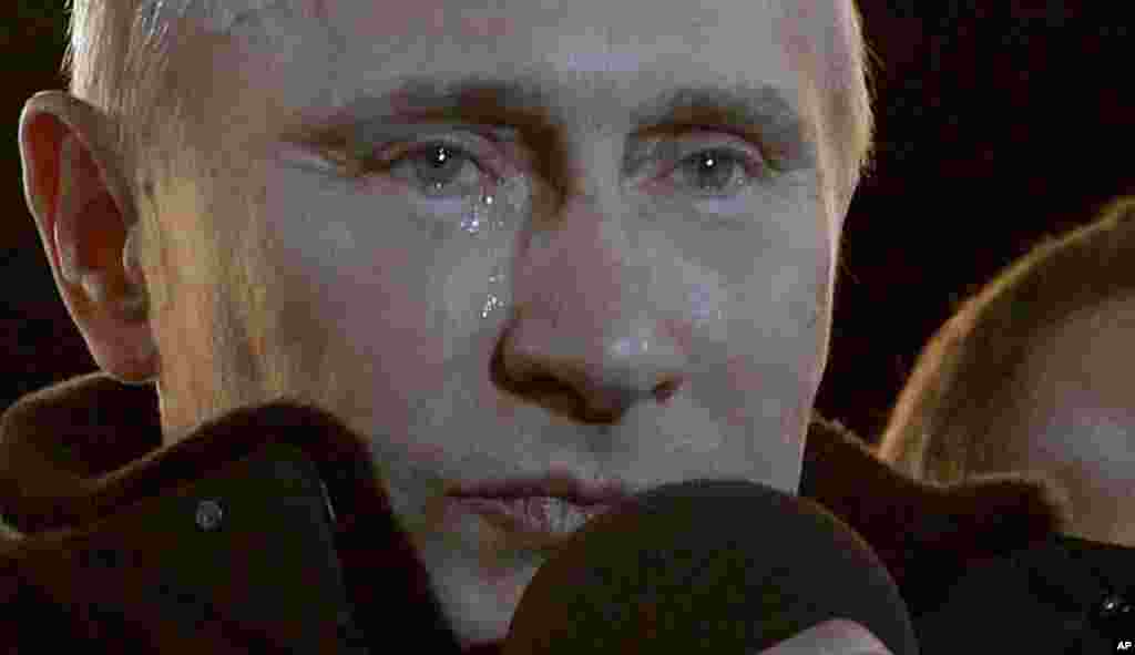 Russian Prime Minister Vladimir Putin who claimed victory in Russia's presidential election, has tears in his eyes at a massive rally of his supporters at Manezh square outside Kremlin, in Moscow, Russia March 4, 2012. (AP)