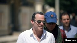 FILE - Brett McGurk, U.S. envoy to the coalition against Islamic State, visits the town of Tabqa, Syria, June 29, 2017.