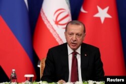Turkish President Tayyip Erdogan speaks during a news conference with President Hassan Rouhani of Iran and Vladimir Putin of Russia following their meeting in Tehran, Iran, Sept. 7, 2018.