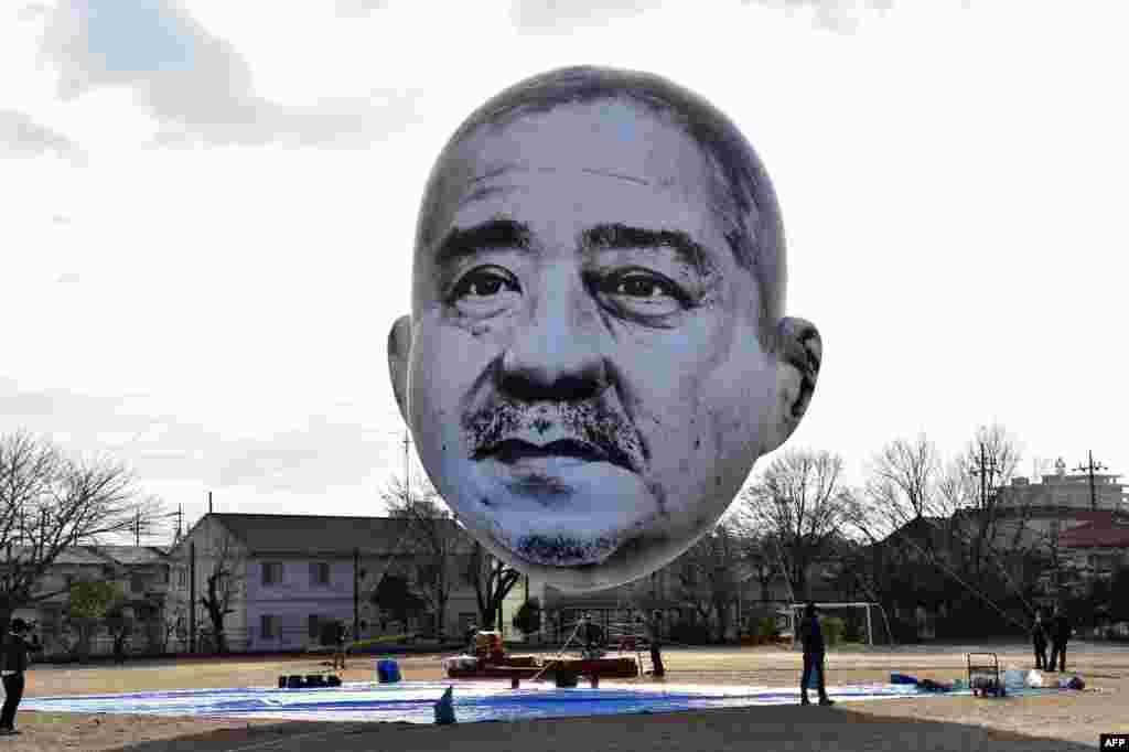 A large balloon of a face of "ojisan", a middle-aged man, floats above the grounds of Nishiki elementary school in Utsunomiya in Tochigi prefecture, 100 km north of Tokyo, Japan. Members of art group "Me", meaning "eye" in Japanese, and the Utsunomiya Museum of Art launched an art installation "The Day an Ojisan's Face Floated in the Sky", a 15-meter by 10-meter face balloon of the depicted man, who was auditioned in the city, looking down on his home town from the sky.