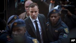 Oscar Pistorius, center, arrives at the High Court in Pretoria, South Africa, July 6, 2016. 