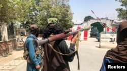 Taliban forces stand guard inside Kabul, Aug. 16, 2021. 