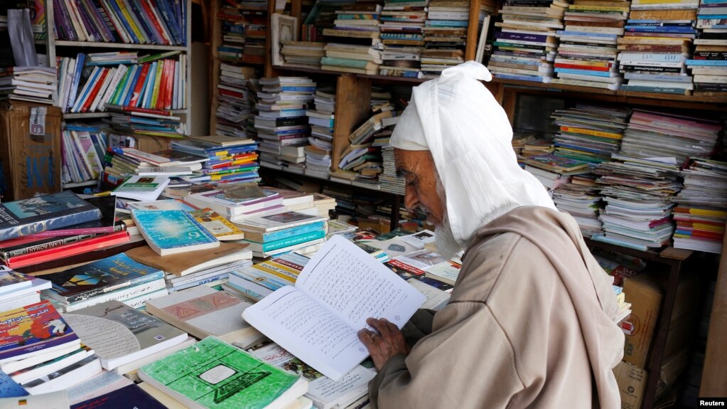 An elderly man reads a book in a bookshop in Bab Doukkala in the city of Marrakech, Morocco, May 13, 2017. (REUTERS/Youssef Boudlal)