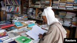 An elderly man reads a book in a bookshop in Bab Doukkala in the city of Marrakech, Morocco, May 13, 2017. (REUTERS/Youssef Boudlal)