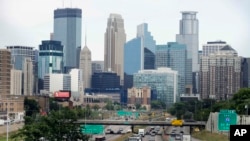 FILE - The Minneapolis skyline rises in the background.