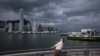 A man looks up on a promenade at Victoria Harbor in Hong Kong on Sept. 5, 2024, as super typhoon Yagi tracked across the South China Sea toward the southern China coast.