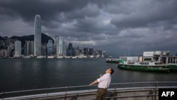 A man looks up on a promenade at Victoria Harbor in Hong Kong on Sept. 5, 2024, as super typhoon Yagi tracked across the South China Sea toward the southern China coast.