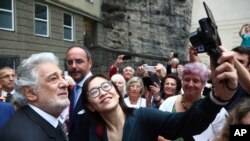 FILE - Placido Domingo poses for selfies at the Festspielhaus opera house after he performed "Luisa Miller" by Giuseppe Verdi in Salzburg, Austria, Aug. 25, 2019. 