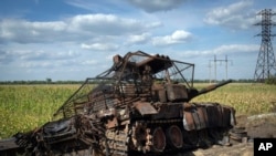 FILE - A destroyed Russian tank sits on a roadside near the town of Sudzha, Russia, in the Kursk region, on Aug. 16, 2024, in an image approved by the Ukrainian Defense Ministry before publication.