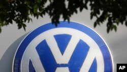 The VW sign of Germany's car company Volkswagen is displayed at the building of a compsny's retailer in, Berlin, Germany, Oct. 5, 2015.