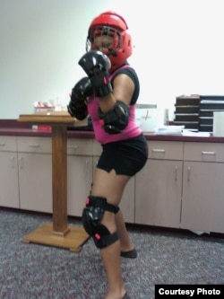 Participants in certified Rape Aggression Defense training wear protective gear to practice repelling an assault.