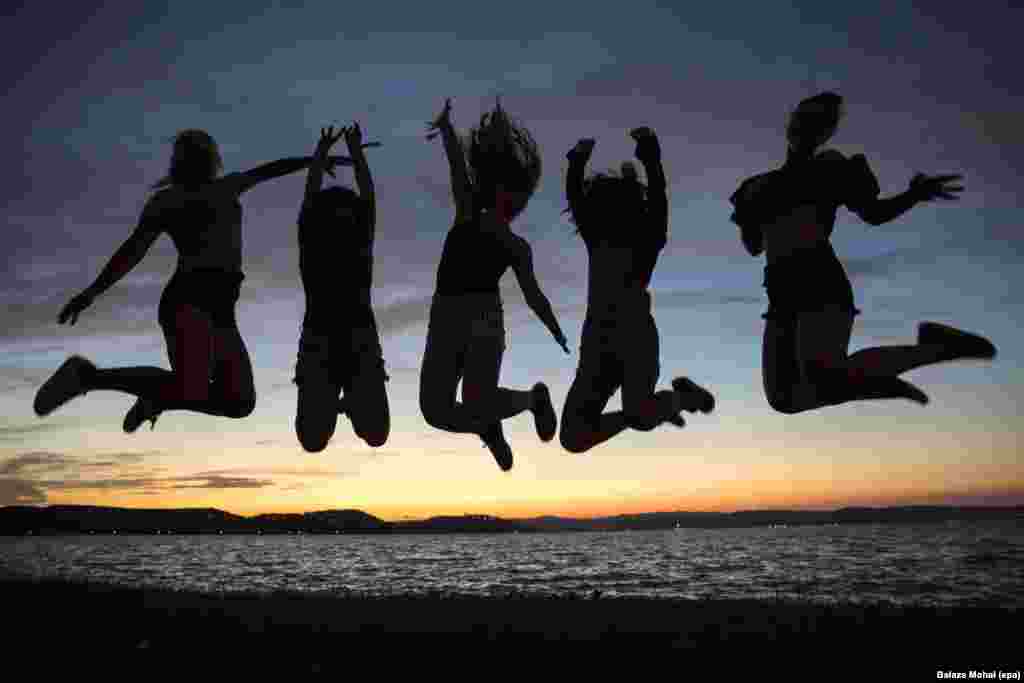 Revelers jump in the air on the shore of Lake Balaton during the opening of Balaton Sound music festival in Zamardi, 110 km southwest of Budapest, Hungary, 06 July 2016.
