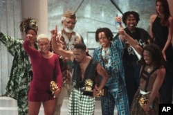 FILE - Members of the band Arrested Development accept their Grammy award at the award show in Los Angeles, Feb. 24, 1993.