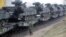 FILE - A German army soldier walks past Marder infantry fighting vehicles at the railway station in Sestokai, Lithuania, Feb. 24, 2017. 