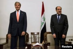 Iraqi Prime Minister Nouri al-Maliki, right, and U.S. Secretary of State John Kerry meet at the Prime Minister's Office in Baghdad, Iraq, June 23, 2014.
