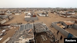 People walk in a shantytown near the port of Hodeida, Yemen, June 16, 2018. 