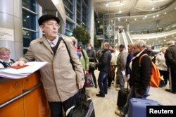 Passengers, whose flights to Egypt were suspended, gather at an information desk of Domodedovo airport outside Moscow, Russia, Nov. 6, 2015.